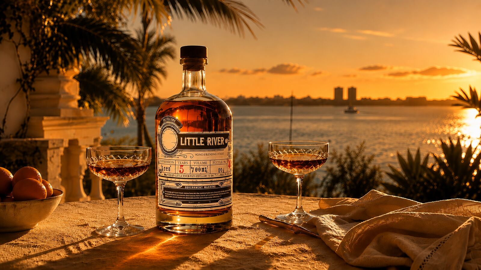Little River rum bottle and two cocktails overlooking the water at sunset