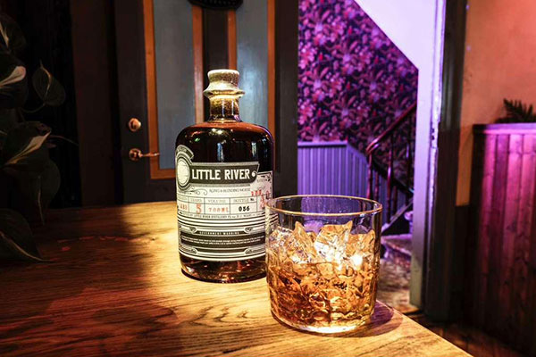 Little River rum with a rocks glass at the bar
